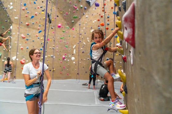 Parent belaying their kid at a Movement Gym