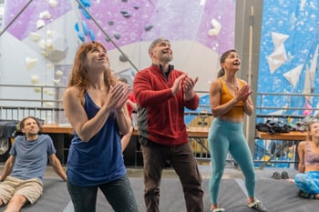 Parents in the boulder area cheering on their kids at a Movement Gym