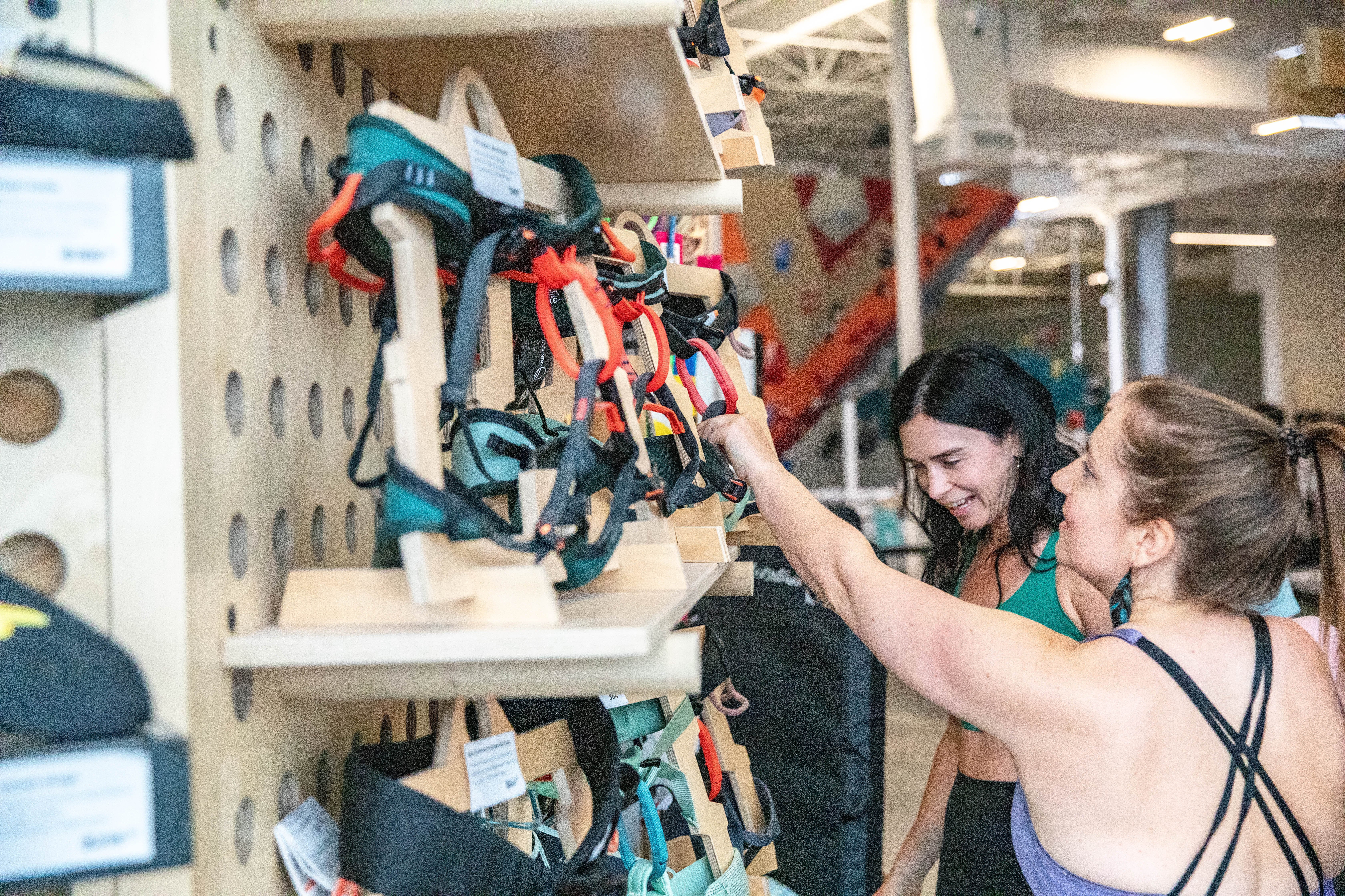 two climbers looking at harnesses