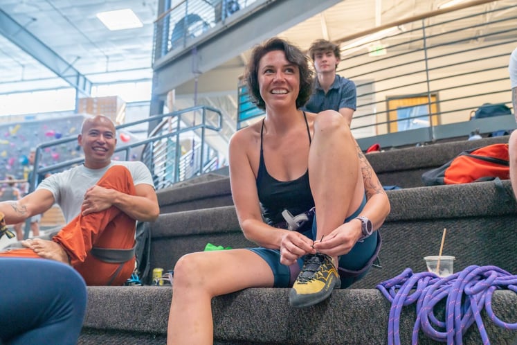 Climber tying shoe laces