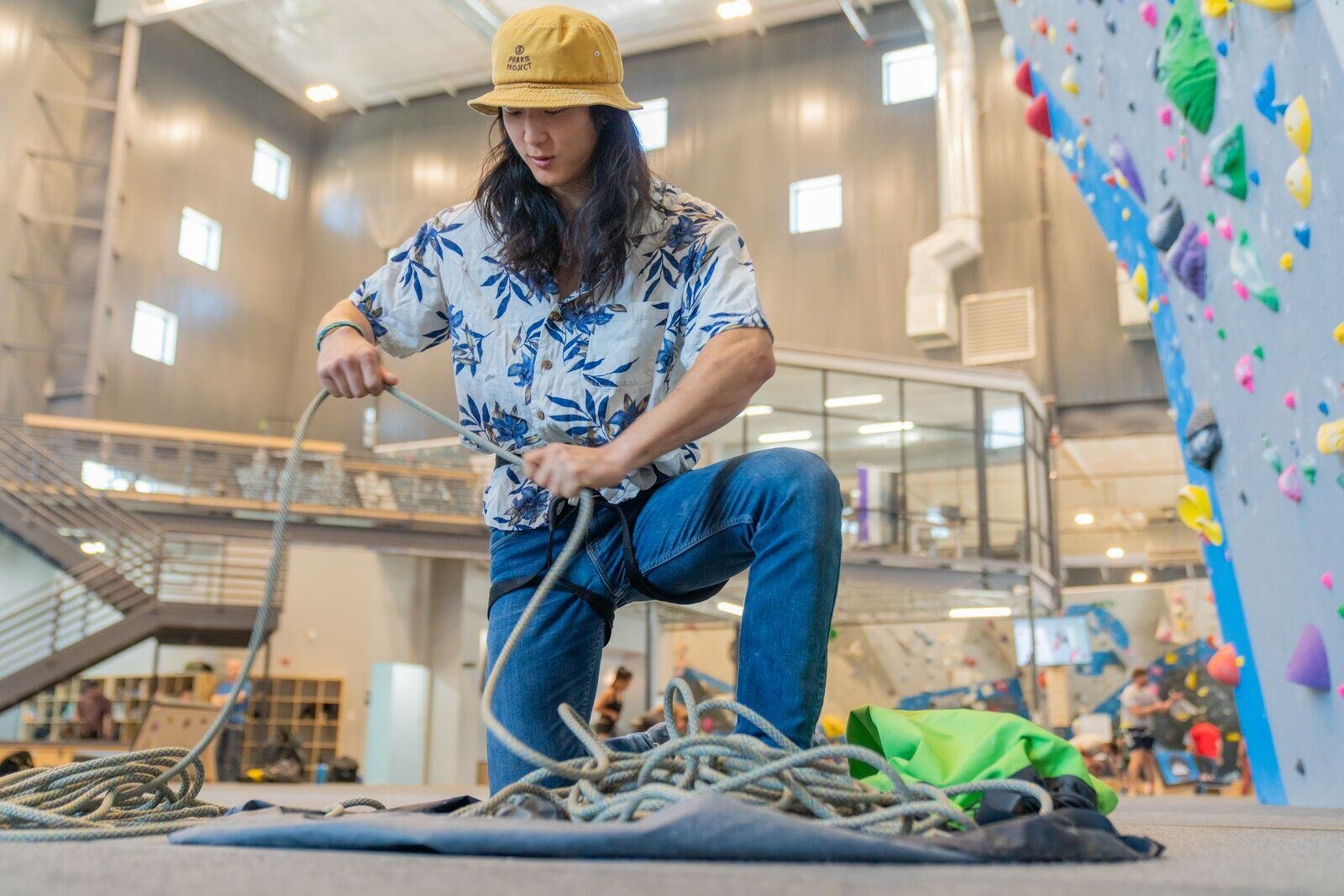 a climber flaking out rope