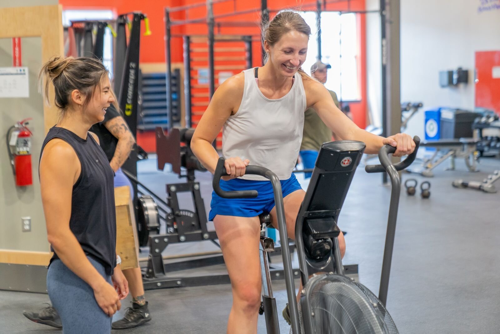 Athlete on a stationary bike being coached by an instructor 