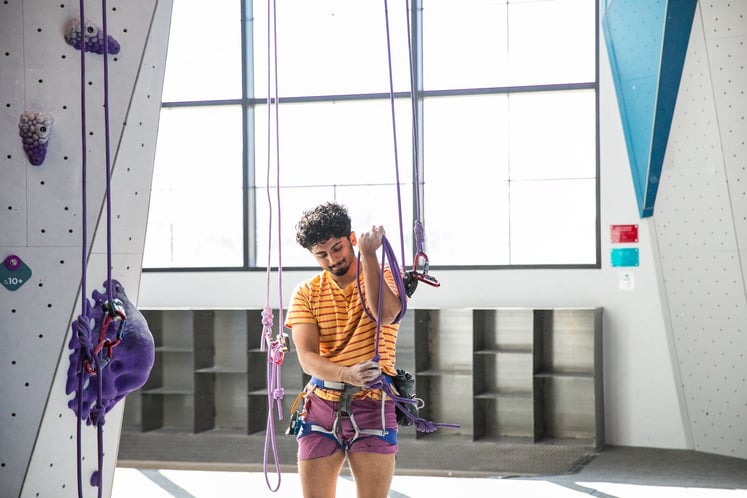 Climber coiling rope 