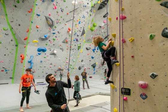 Parent belaying their child at a Movement Gym