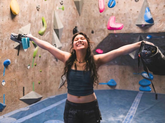 climber smiling with arms spread out
