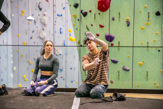 Members working out a boulder problem at Movement Design District