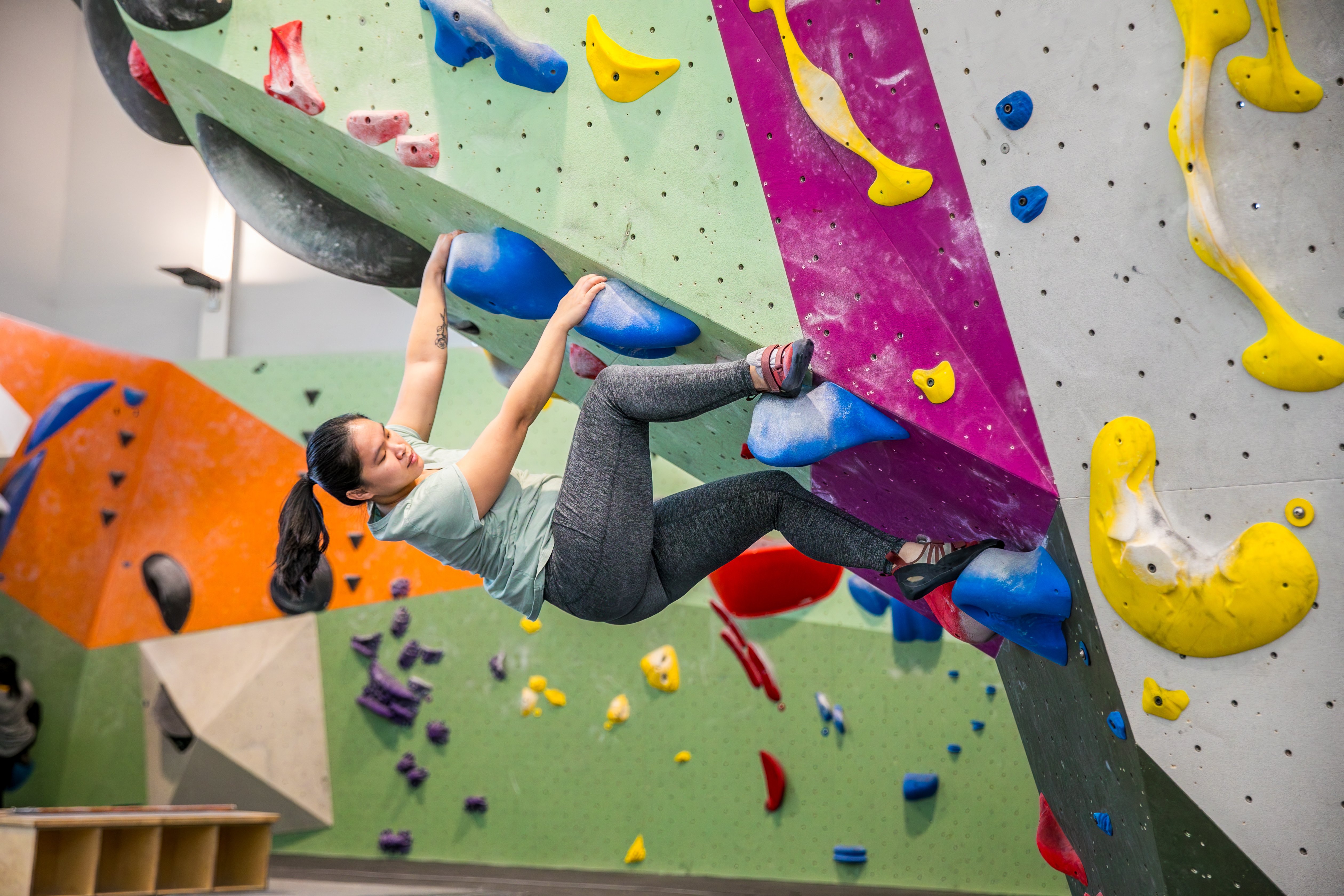 Climber heel hooking while bouldering
