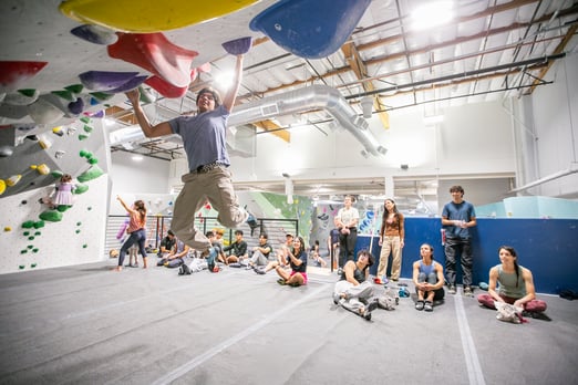 Climbers cheering on a climber at Movement Mountain View