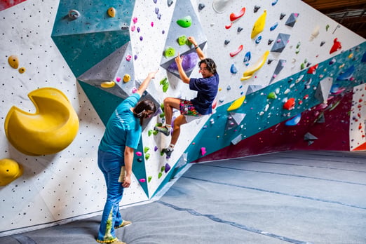 Climbing instructor giving beta to a climber at Movement Santa Clara